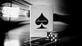 Madison Rounders playing cards box standing on a reflective surface, with two dice and part of a playing card in front, photographed in a dramatic black-and-white setting.