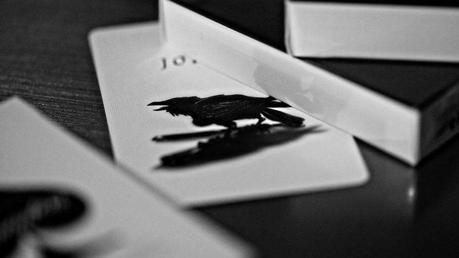 A close-up bMadison Black Rounders playing cards joker showing a raven 