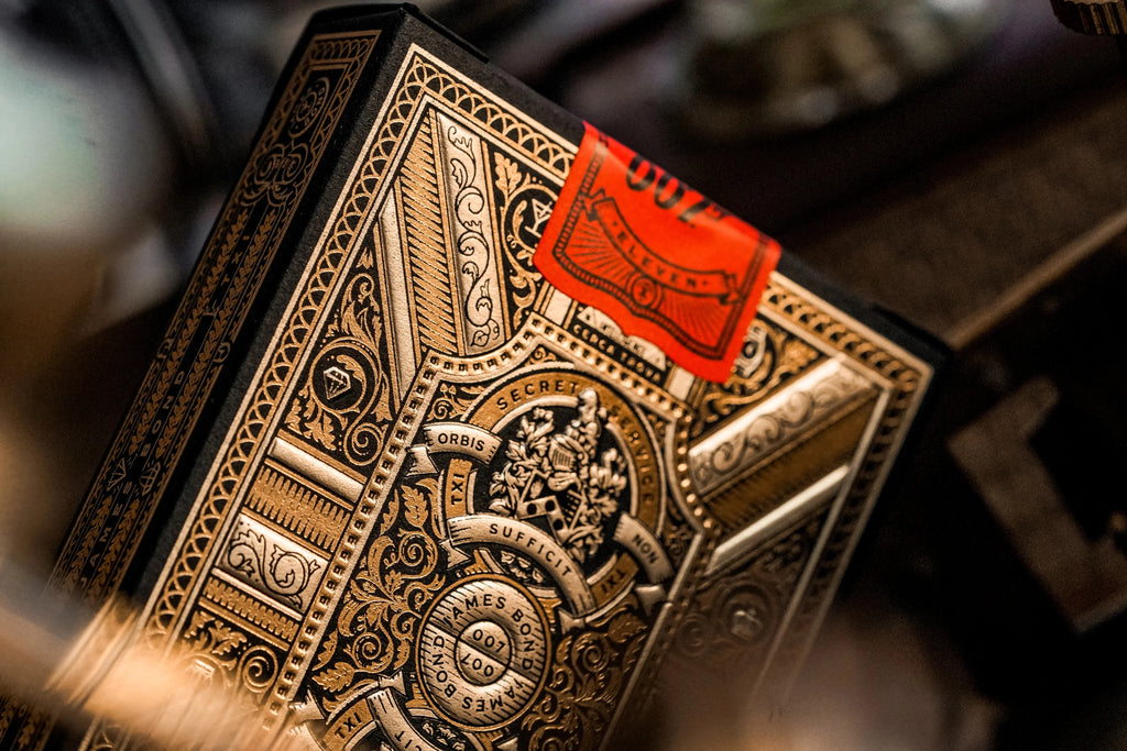 James Bond 007 Playing Cards by Theory11 — premium collector deck lifestyle shot with custom 007 deck seal