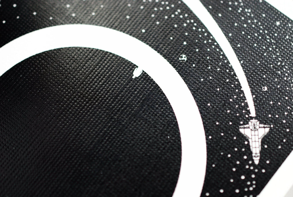 Orbit V4 Playing Cards by Orbit Brown —closeup shot of card back showcasing Space-themed design with a spacecraft and celestial body on a black background