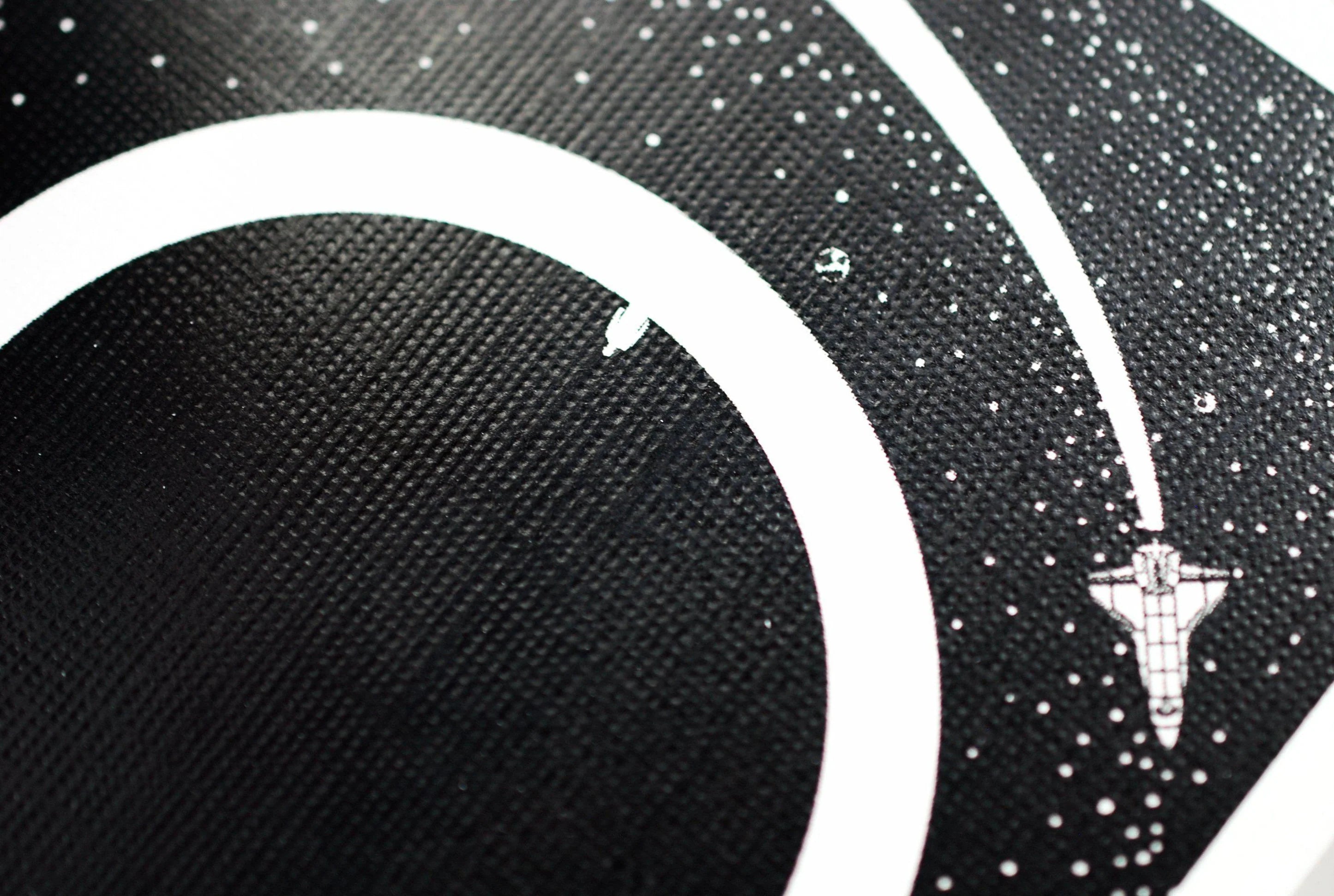 Orbit V4 Playing Cards by Orbit Brown —closeup shot of card back showcasing Space-themed design with a spacecraft and celestial body on a black background