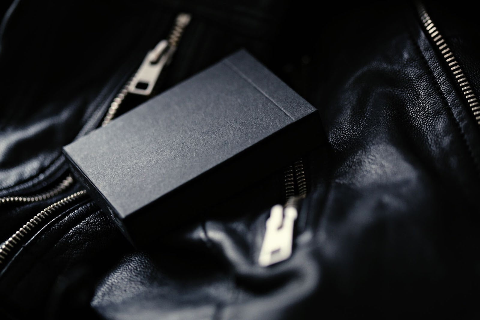 Madison Rounders White Playing Cards — matte black tuck box on textured dark surface, Daniel Madison deck