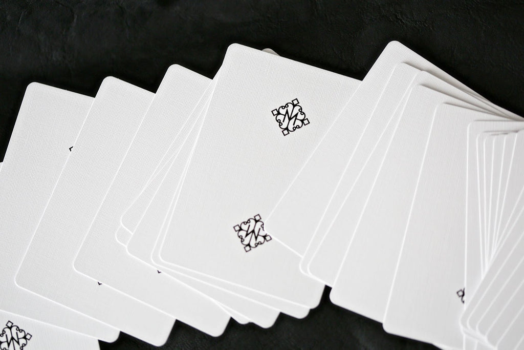 Madison Rounders White Playing Cards by Daniel Madison — full deck fanned on black background